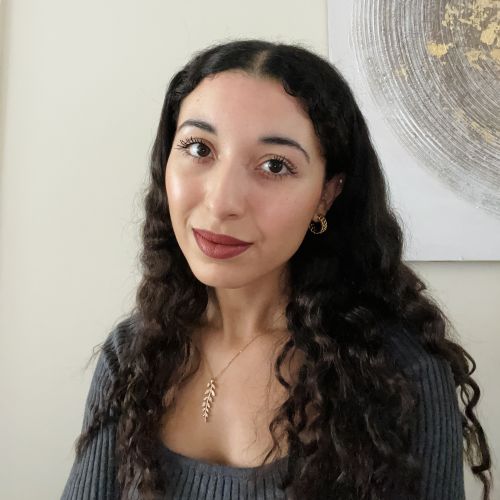 Picture of the founder, a woman with wavy brown hair.